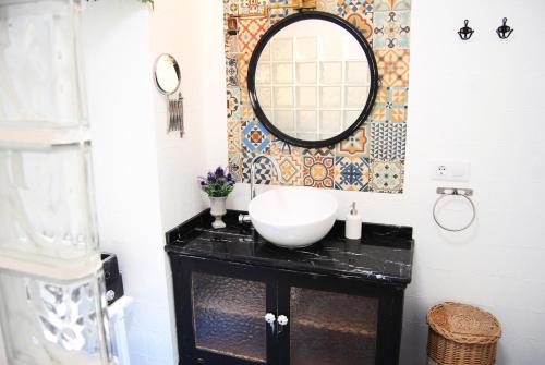 W łazience znajduje się umywalka i lustro. w obiekcie El Patio del Limonero w mieście Écija