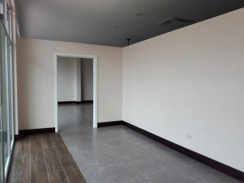 an empty room with white walls and a tile floor at Hotel PZ Country Club & Conference Center in San Isidro