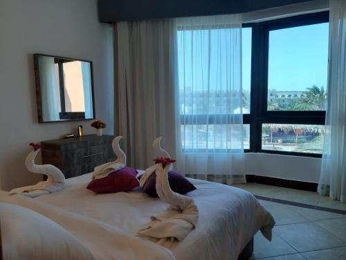 Ένα ή περισσότερα κρεβάτια σε δωμάτιο στο Alia Beach Residence