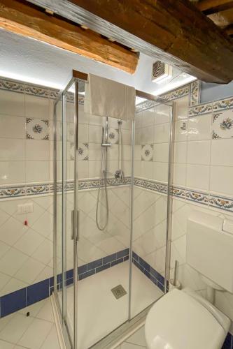 a bathroom with a toilet and a shower at Princess Art Hotel in Ferrara