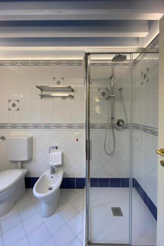 a bathroom with a shower and a toilet and a sink at Princess Art Hotel in Ferrara