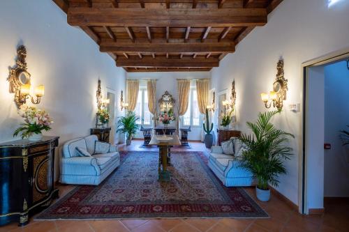 a large living room with two chairs and a table at Princess Art Hotel in Ferrara