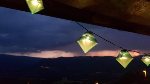 a group of lights hanging from a string at night at Casa Ton del Mingo in Sant Cerni