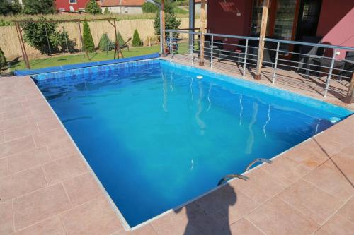 a swimming pool with blue water in a house at Vila Viktori in Pirot