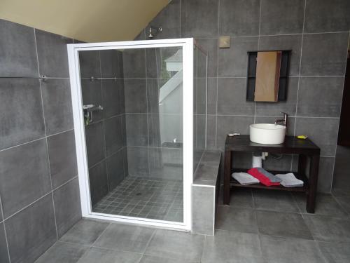 a shower with a glass door in a bathroom at Ungabona in East London