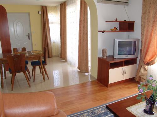 a living room with a couch and a tv and a table at Dona Apartments in Ohrid
