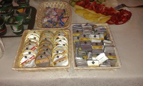 two trays filled with different types of food on a table at Tiffán's Pincészet és Panzió in Villány