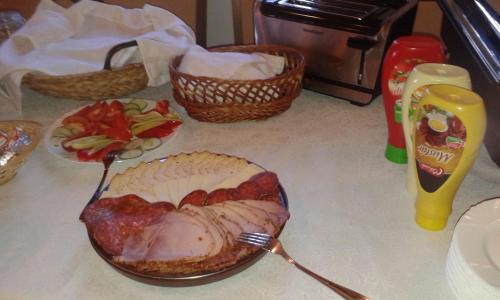 a turkey in a bowl with a fork on a table at Tiffán's Pincészet és Panzió in Villány