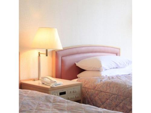 Tempat tidur dalam kamar di Hotel Ajour Shionomaru - Vacation STAY 92336
