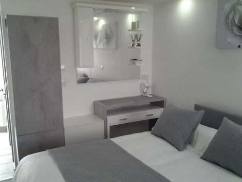 a bedroom with a bed and a sink and a mirror at Lady Charlotte Guest rooms triple rooms in Dowlais