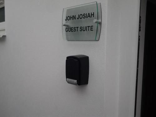 a black box on a wall with a guest suite sign at Lady Charlotte Guest rooms triple rooms in Dowlais