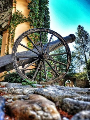 a wooden wagon wheel sitting next to a building at Zamek Otmuchów in Otmuchów
