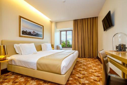 a hotel room with a large bed and a window at Sintra Boutique Hotel in Sintra