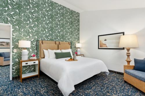 a hotel room with a bed and a chair at Mason Beach Inn in Santa Barbara