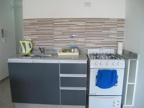 a kitchen with a stove and a sink at B&B Mono ambiente in San Miguel de Tucumán