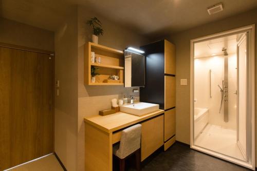 a bathroom with a sink and a bath tub at R&Run Kyoto Serviced apartment & Suites - Vacation STAY 93241 in Kyoto