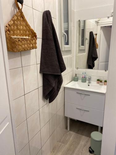 a bathroom with a sink and a mirror at joli appartement quartier historique, 5 pers in Moulins