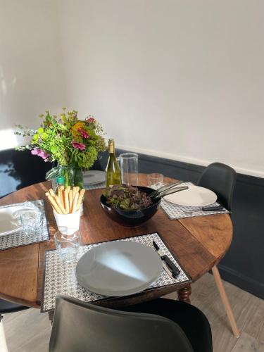 a table with a plate of food and a bottle of wine at joli appartement quartier historique, 5 pers in Moulins
