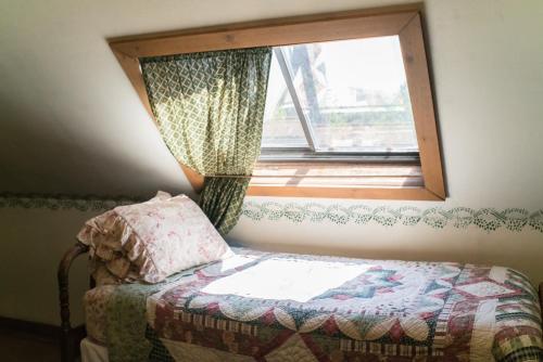 a bed in a room with a window at The Mulberry Inn -An Historic Bed and Breakfast in St. George