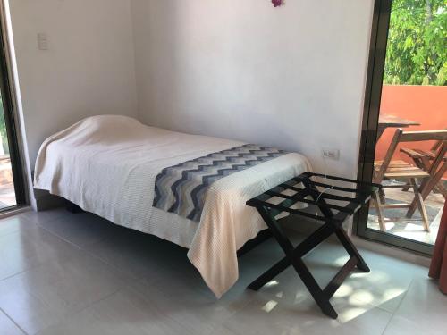 a bedroom with a bed and a glass table at Casa Mango in Valladolid