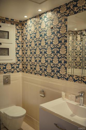 a bathroom with a toilet and a sink at Miramar Boutique Hotel in Alexandria