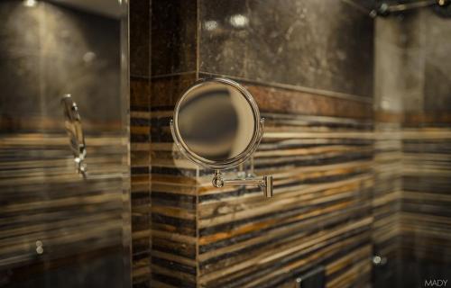 a mirror on the wall of a bathroom at Miramar Boutique Hotel in Alexandria