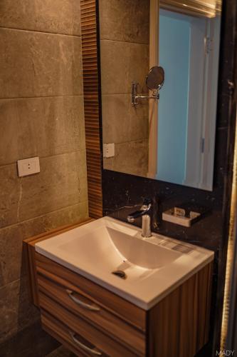 a bathroom with a sink and a mirror at Miramar Boutique Hotel in Alexandria