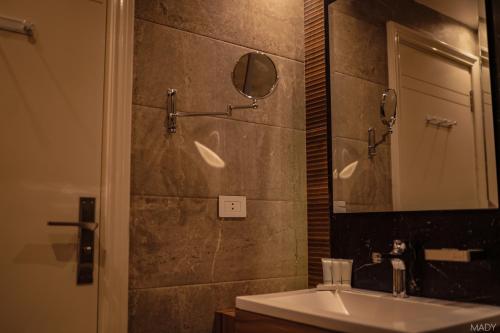 a bathroom with a sink and a mirror at Miramar Boutique Hotel in Alexandria