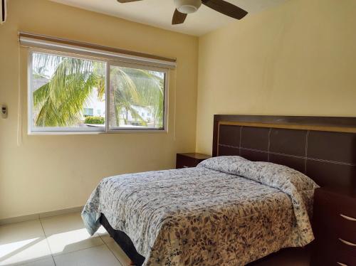 a bedroom with a bed and a window at Villa Perfecta Zona Diamante in Acapulco