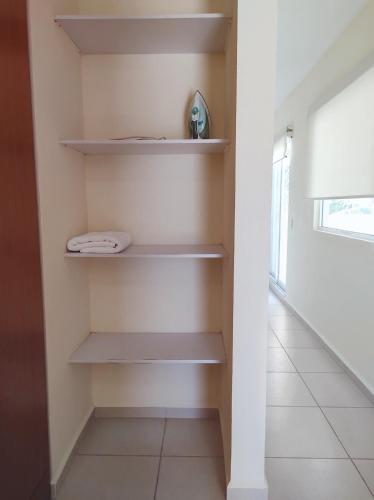 a walk in closet with shelves in a room at Villa Perfecta Zona Diamante in Acapulco