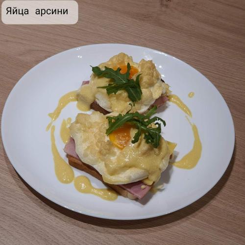 a white plate of food with an egg on it at Sport Hotel 1 in Cherkasy