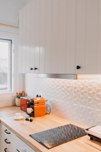 a kitchen with an orange toaster on a counter at the SummerHouse Project in Perítheia