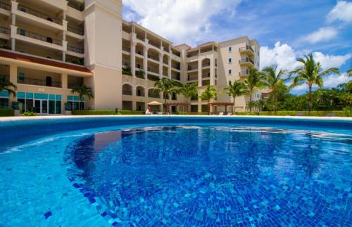una grande piscina di fronte a un edificio di Landmark by Villas Segovia a Cozumel