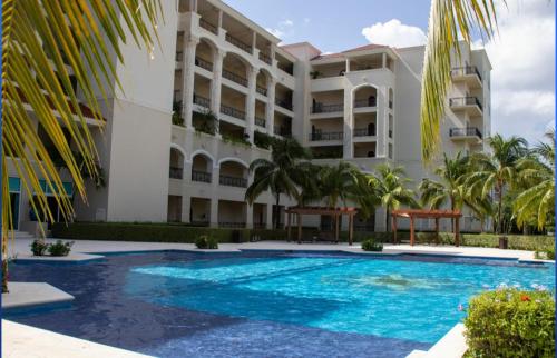 a swimming pool in front of a building at Landmark by Villas Segovia in Cozumel