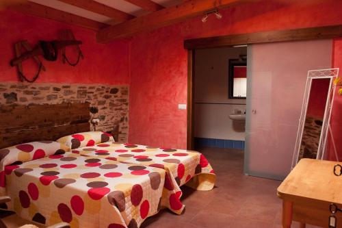 a bedroom with a bed in a room with red walls at Calzada Romana in Cedeira