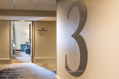 a hallway with a letter s on a wall at Best Western Linko Aubagne in Aubagne