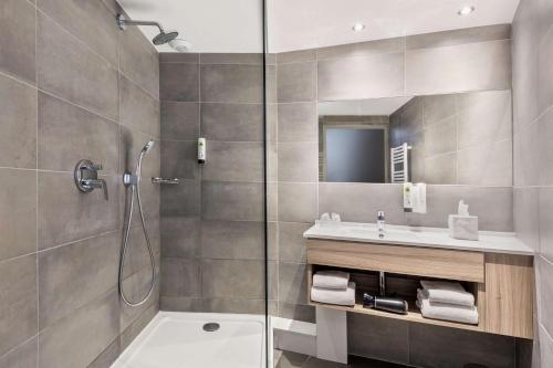 a bathroom with a shower and a sink at Best Western Linko Aubagne in Aubagne