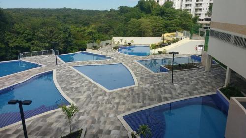 an overhead view of three swimming pools on a building at Park Veredas Apart in Rio Quente