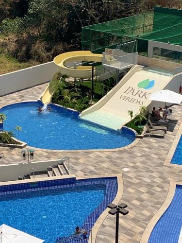 a large swimming pool with a slide and a swimming pool at Park Veredas Apart in Rio Quente