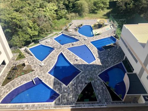 an aerial view of a swimming pool with blue water at Park Veredas Apart in Rio Quente