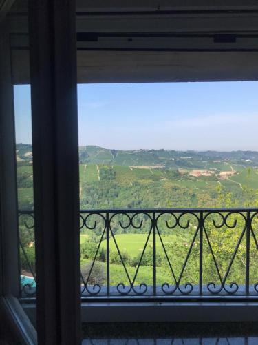 a window with a view of a green field at Agriturismo Brusalino in Mango