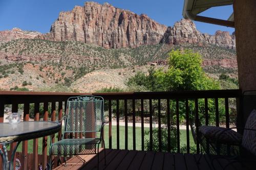 a balcony with a table and chairs and a mountain at Harvest House Bed and Breakfast in Springdale