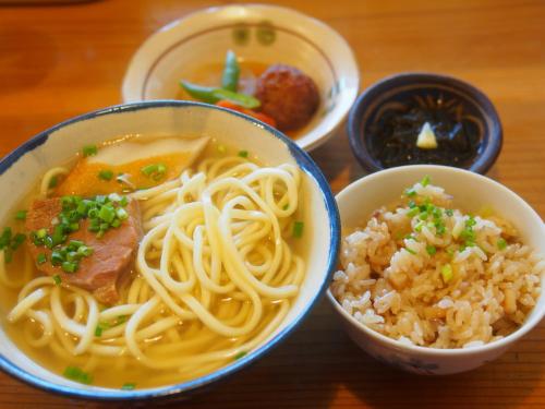 a table topped with bowls of soup and rice at Ecot Shimozato 3 in Miyako Island