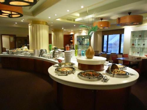 a buffet in a restaurant with several plates of food at The Palazzo Hotel in Bangkok