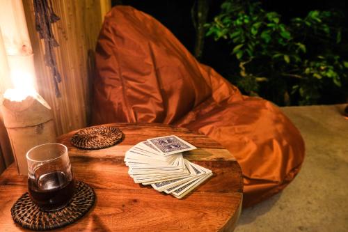 a wooden table with a glass of wine on a chair at Desa Eko in Munduk