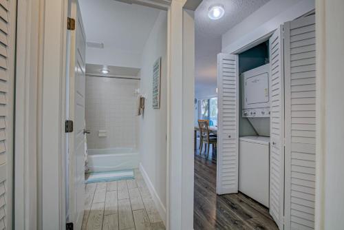 a bathroom with a walk in shower next to a door at Anna Maria Island Beach Palms 7A in Bradenton Beach