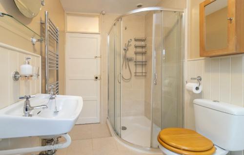 a bathroom with a shower and a toilet and a sink at Number Five in Somerton