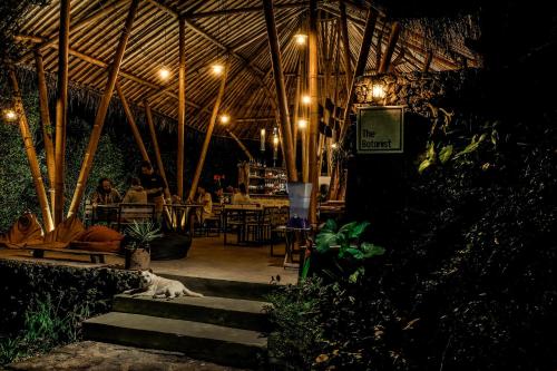 a cat laying on steps in a restaurant at night at Desa Eko in Munduk