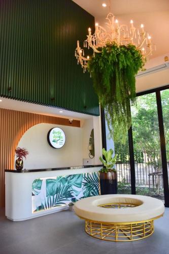a room with a table and a chandelier at JINGLE JUNGLE RESORT KHAOYAI in Mu Si