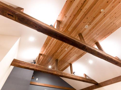 a wooden ceiling in a room with wooden beams at The Kura in Iiyama